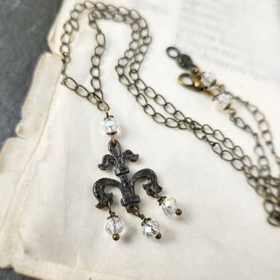 fleur de lis amulet - antiqued bronze with iridescent glass