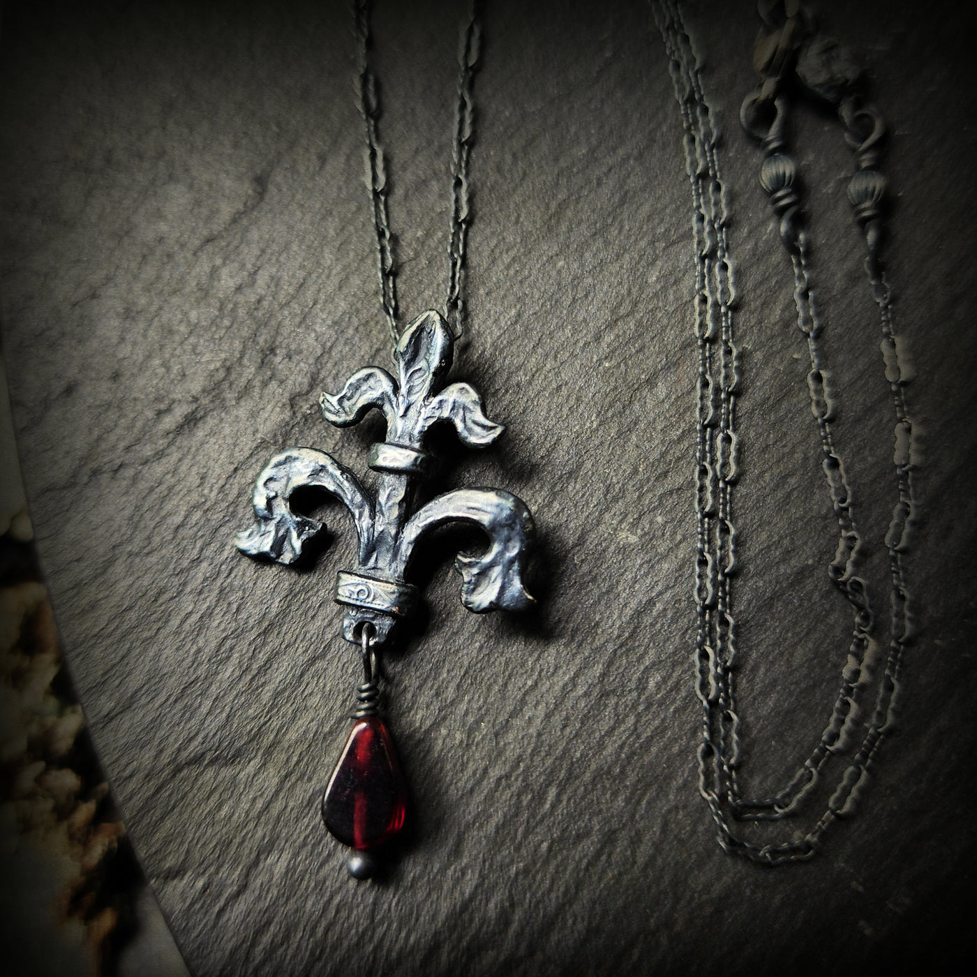 fleur de lis amulet - antiqued sterling with garnet