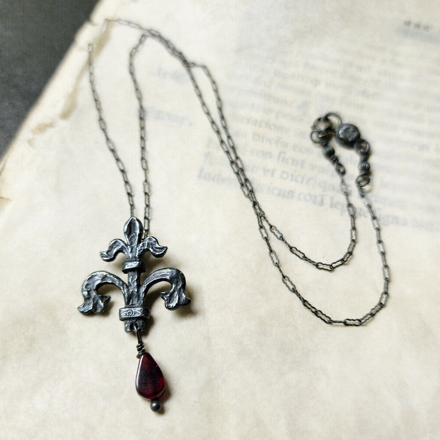 fleur de lis amulet - antiqued sterling with garnet